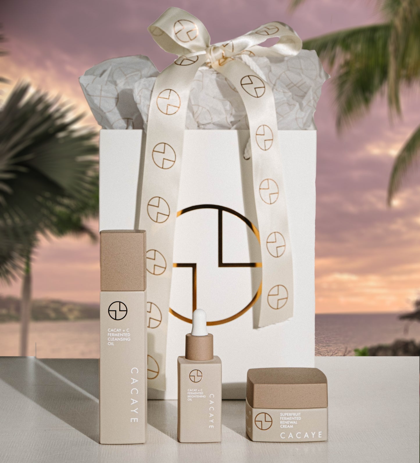 
                  
                    CACAYE CaCay + Fermented Skincare Trio Holiday Set  with Gift Bag and Ribbon with tropical background
                  
                