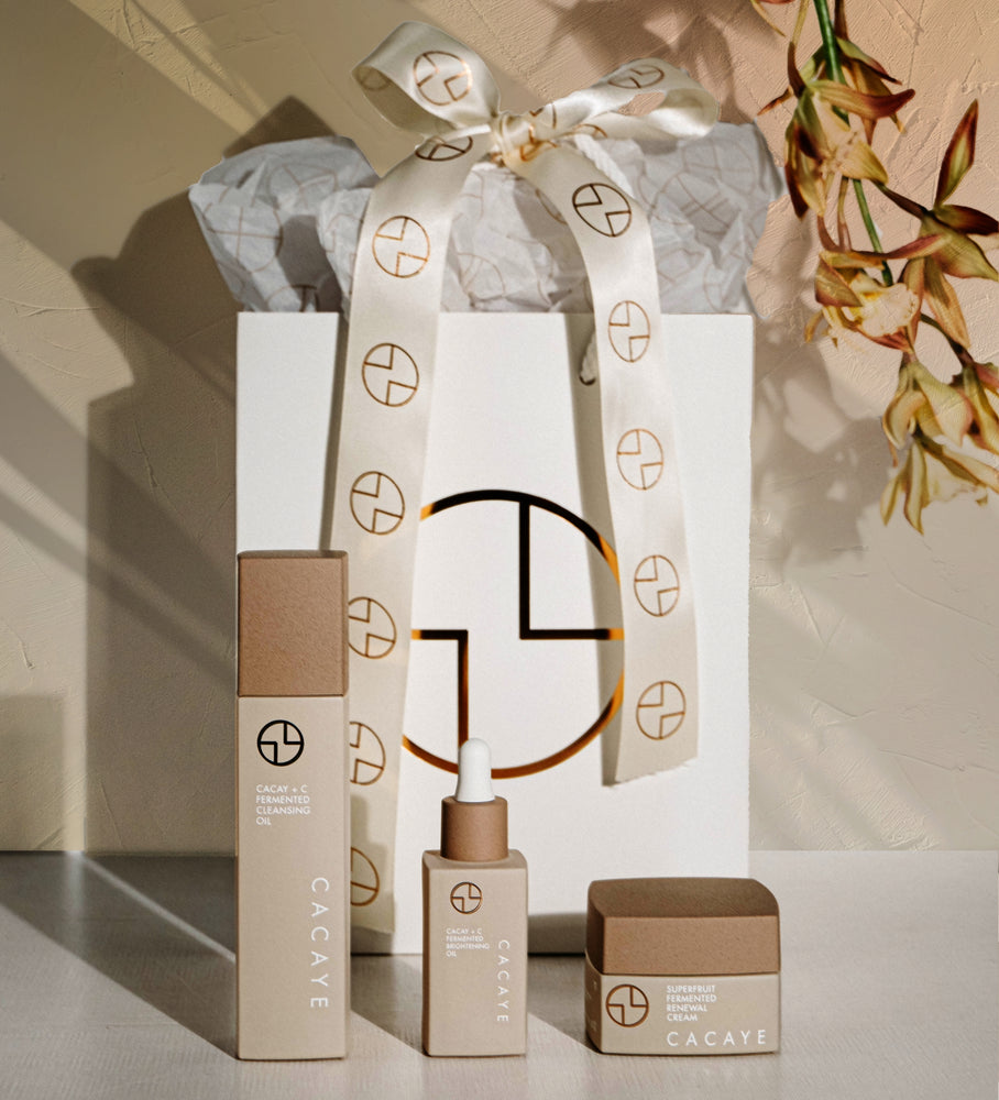 CACAYE CaCay + Fermented Skincare Trio Holiday Set  with Gift Bag and Ribbon with Mosaic background